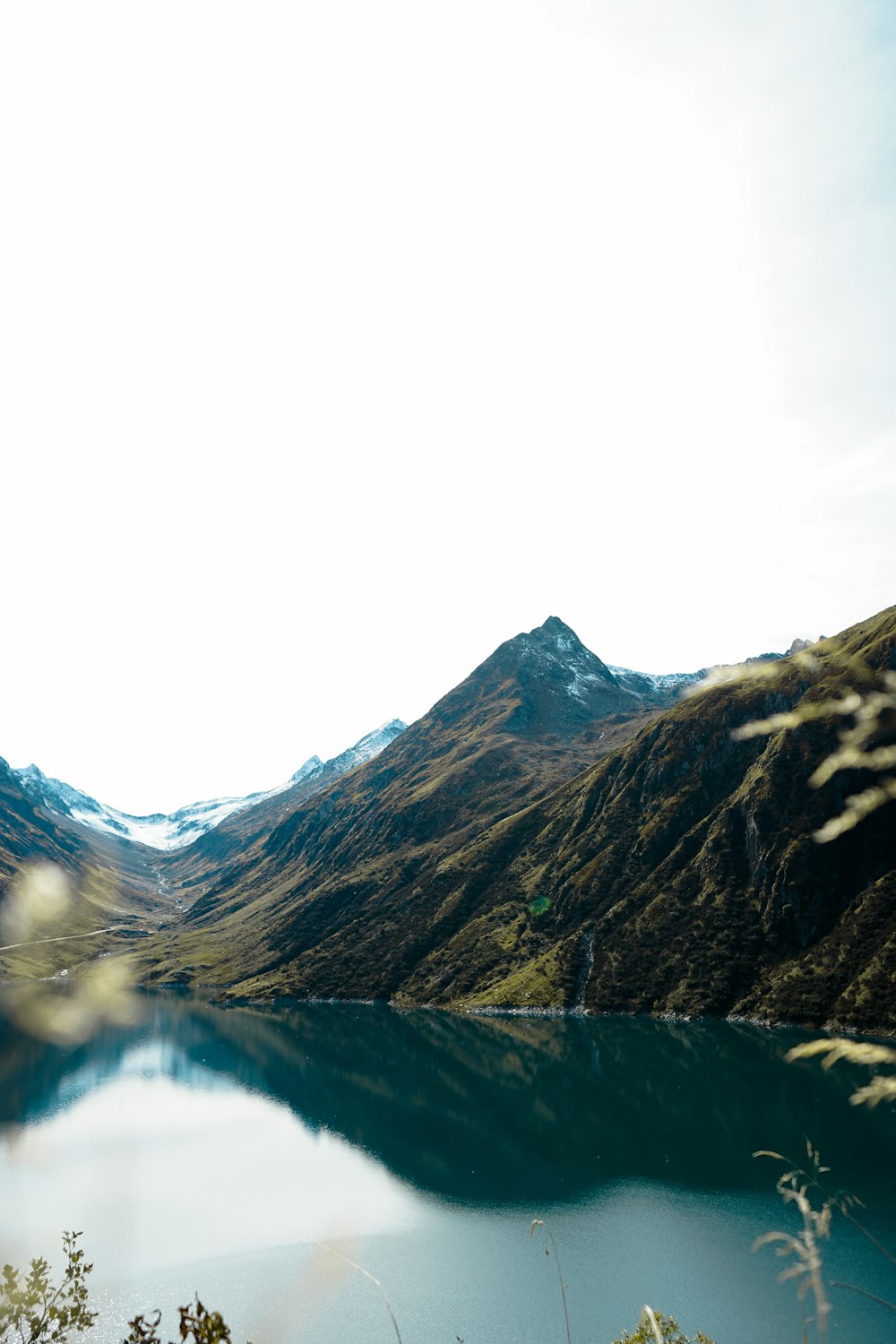 a body of water with mountains in the background