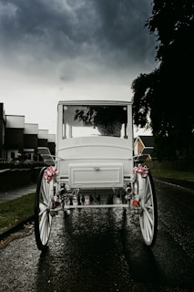 an old white car with flowers in it