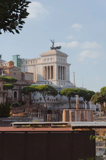 a large white building with columns and a statue on top