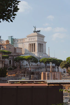 a large white building with columns and a statue on top