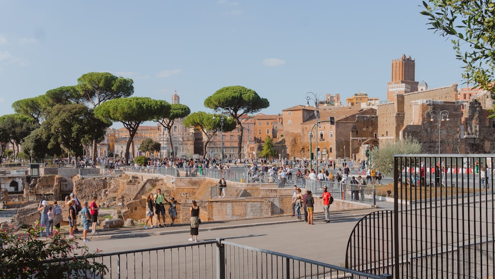 a group of people walking around a city