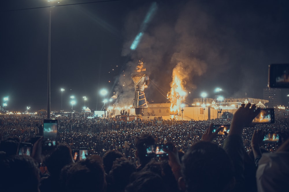 a large crowd of people watching a stage with a large crowd watching