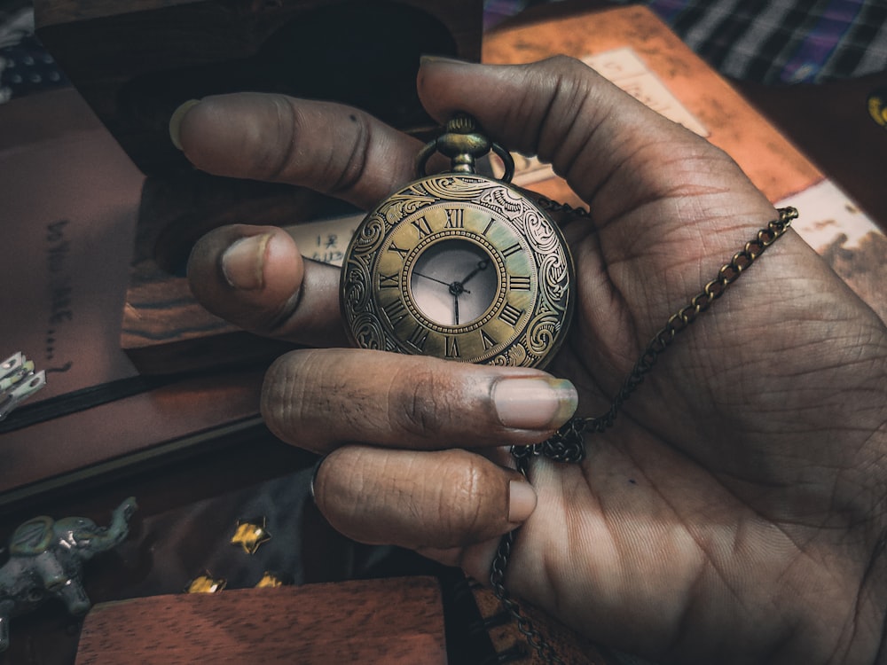 a hand holding a watch