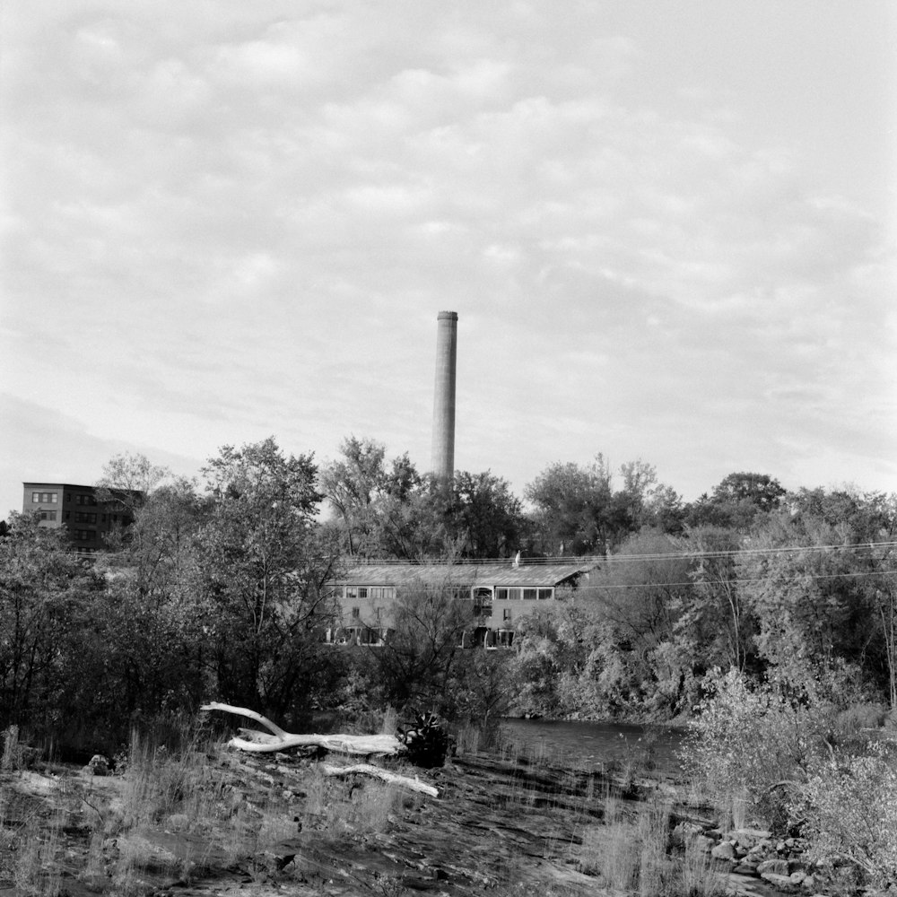 a building with a smokestack in the background