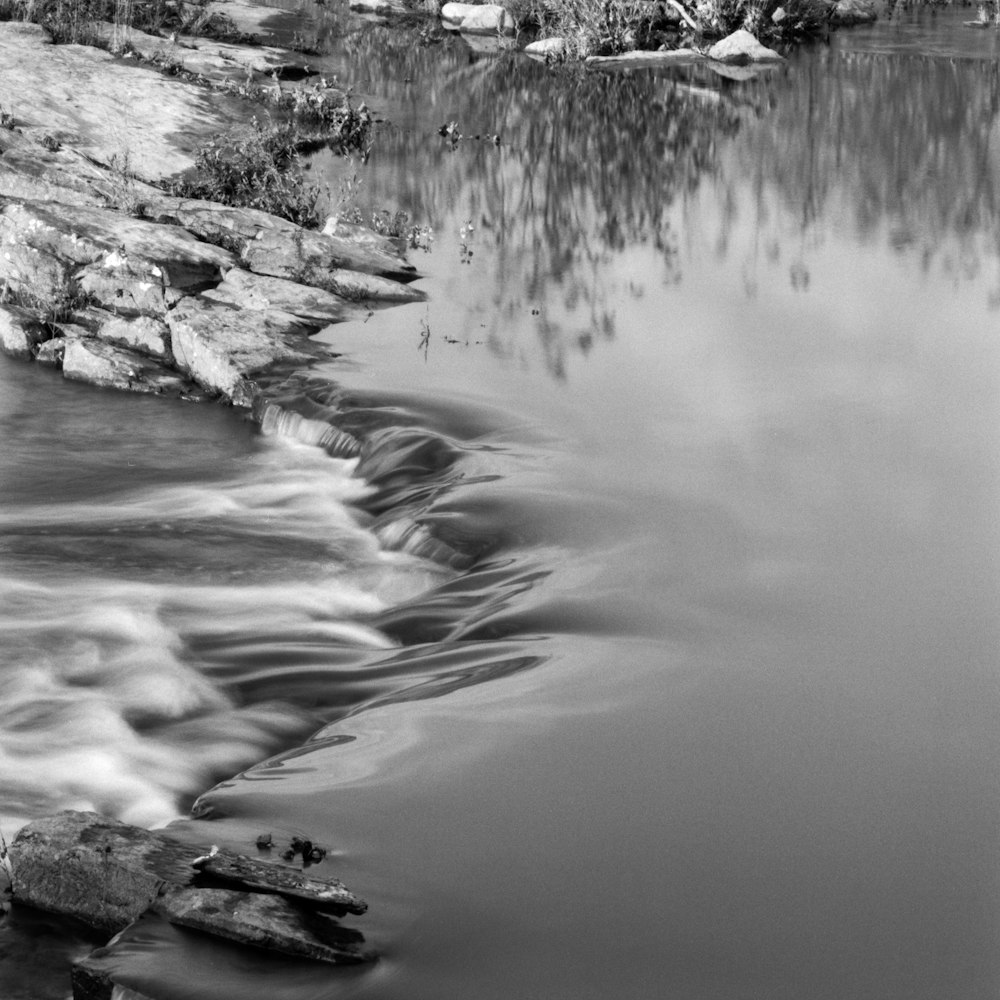 a river with rocks and a waterfall