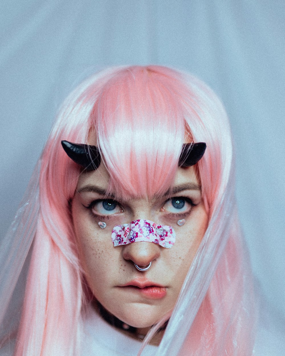 a woman with pink hair and a flower in her hair