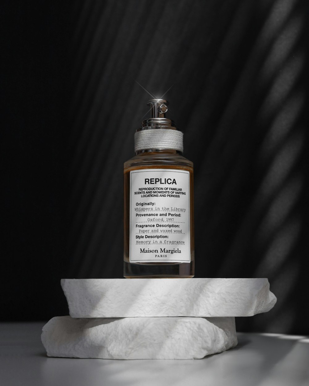 a bottle of perfume on a white towel