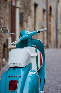 a blue Vespa with italian flag