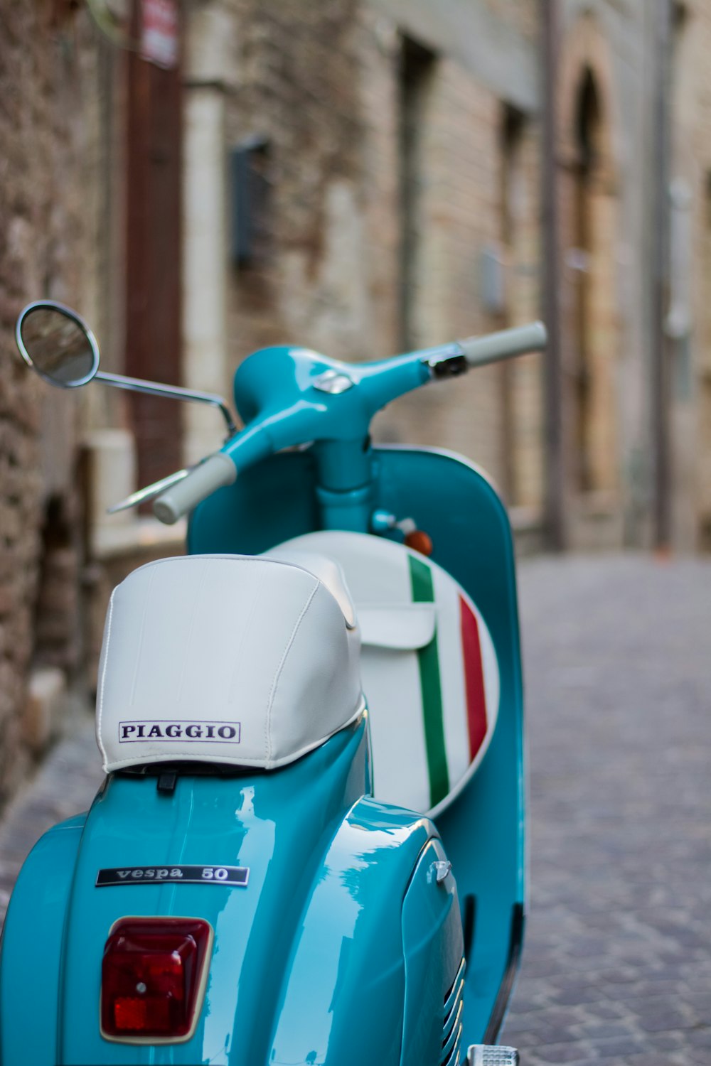 a blue scooter parked on a street