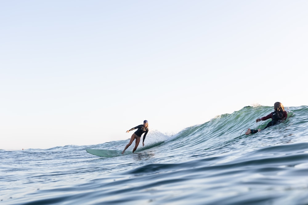 surfers riding a wave