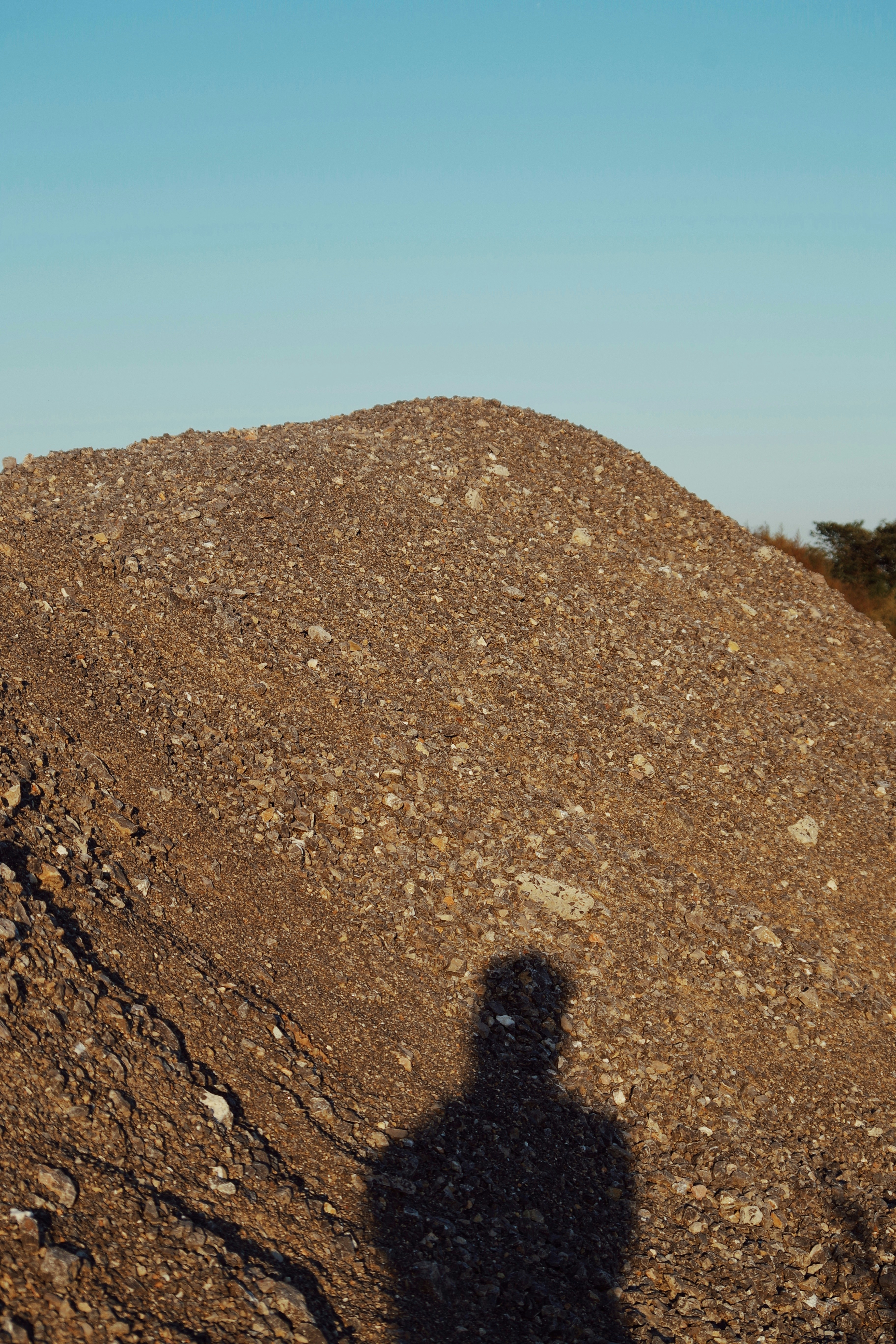 a shadow of a person on a rock