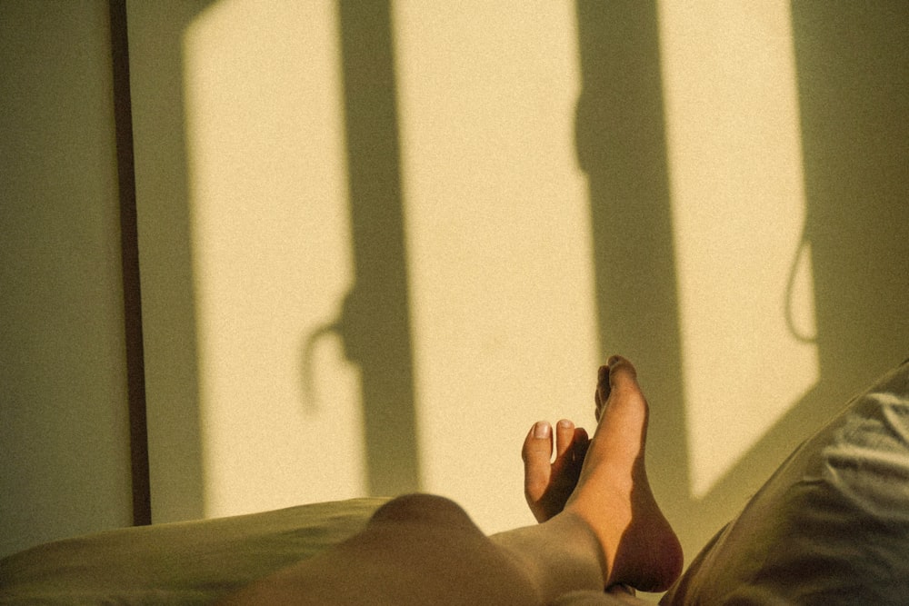 a person's feet on a bed