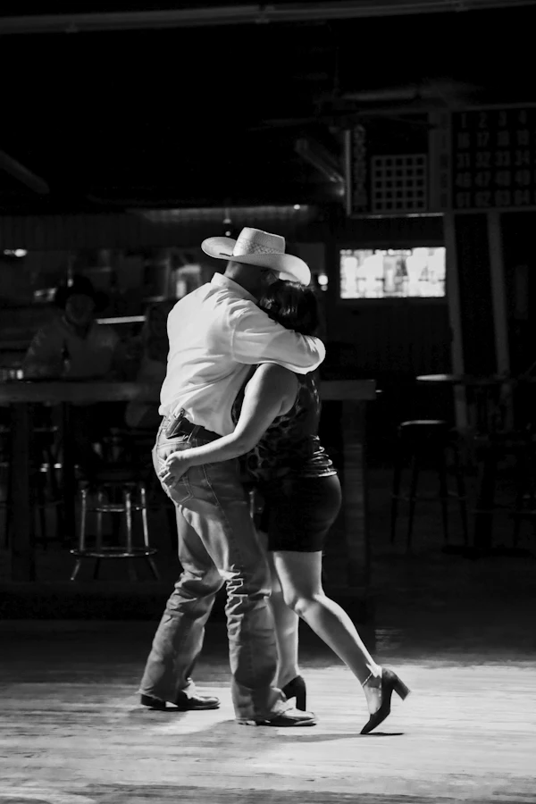 A couple two-stepping in a dance hall