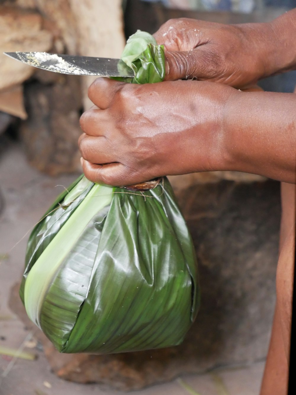 a person cutting a vegetable