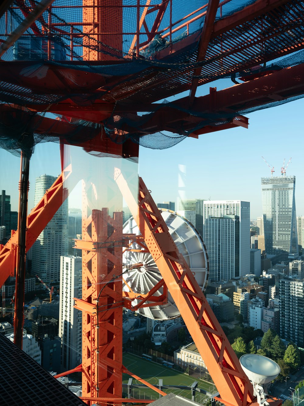 a roller coaster with a city in the background