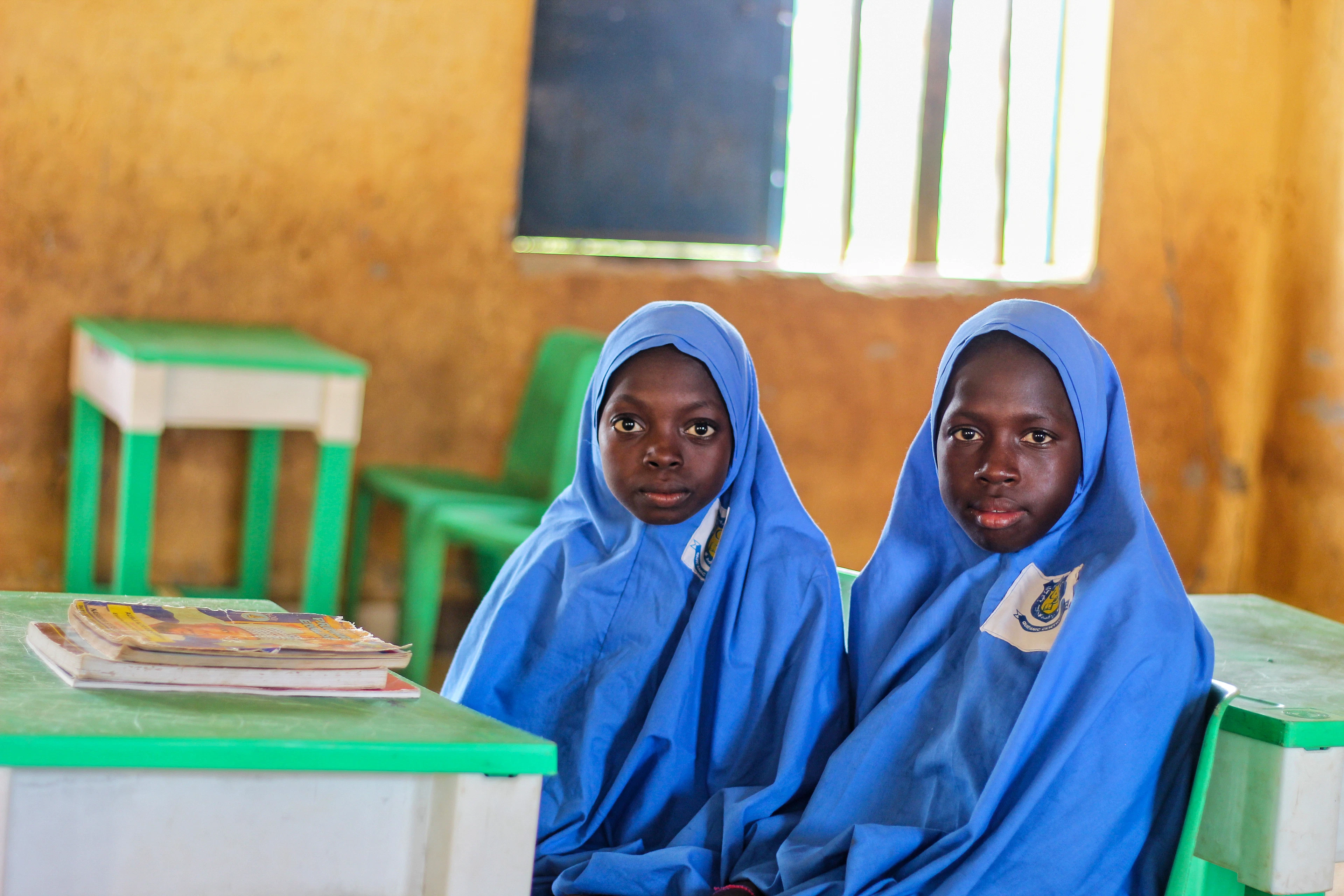 Two women in blue robes