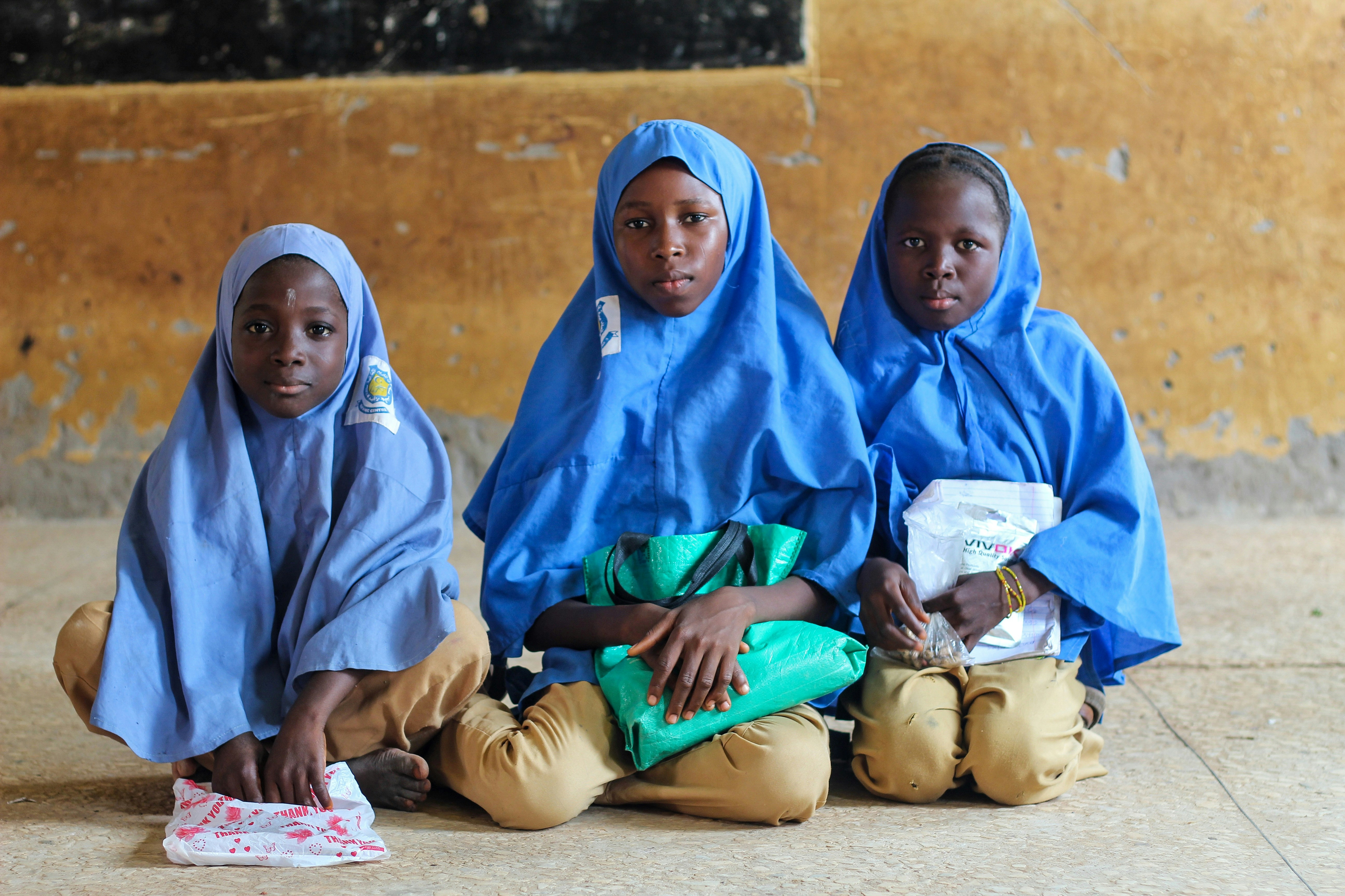 a group of women sitting on the ground