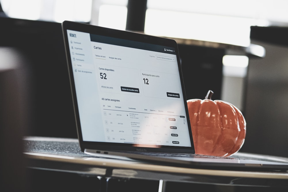 a tablet with a screen and a pumpkin on a table