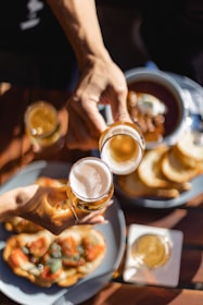 a person holding a glass of beer