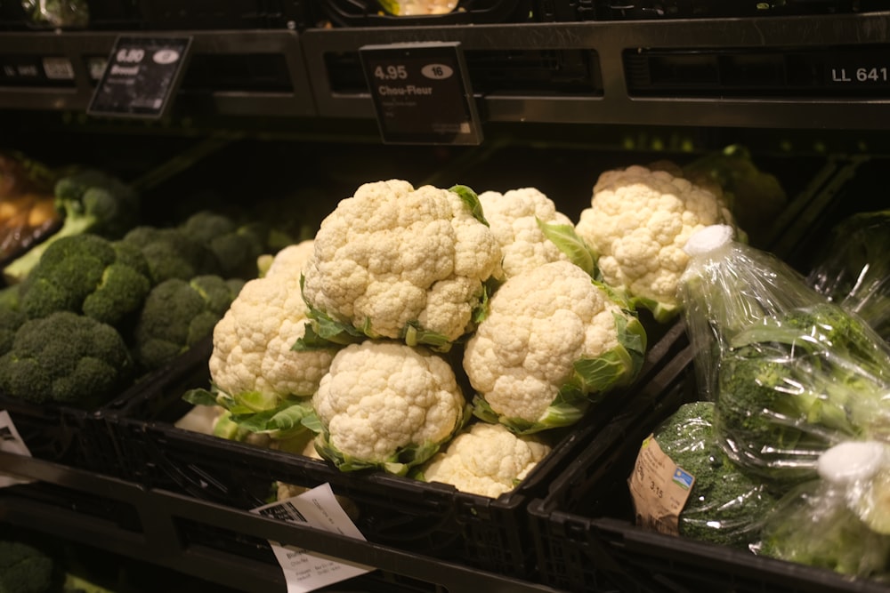 a bunch of cauliflowers in a grocery store