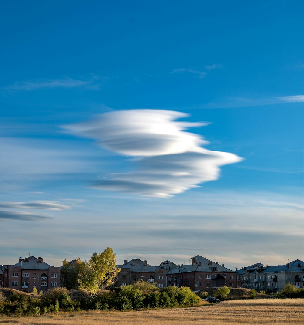 a group of houses with a blue sky above