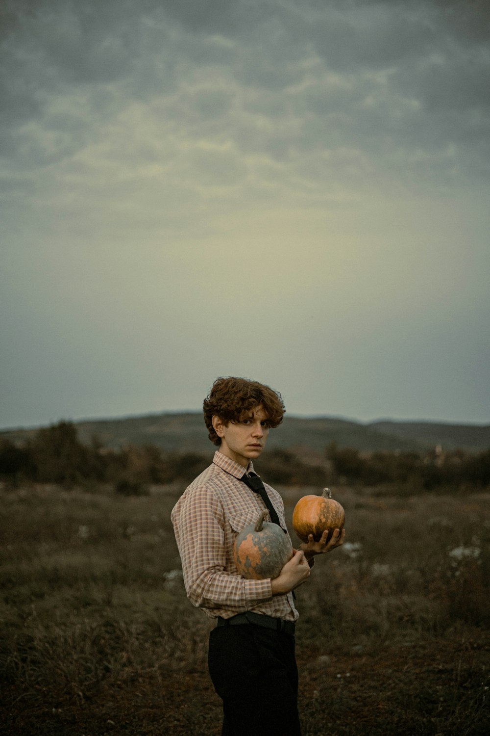 a boy holding a pumpkin