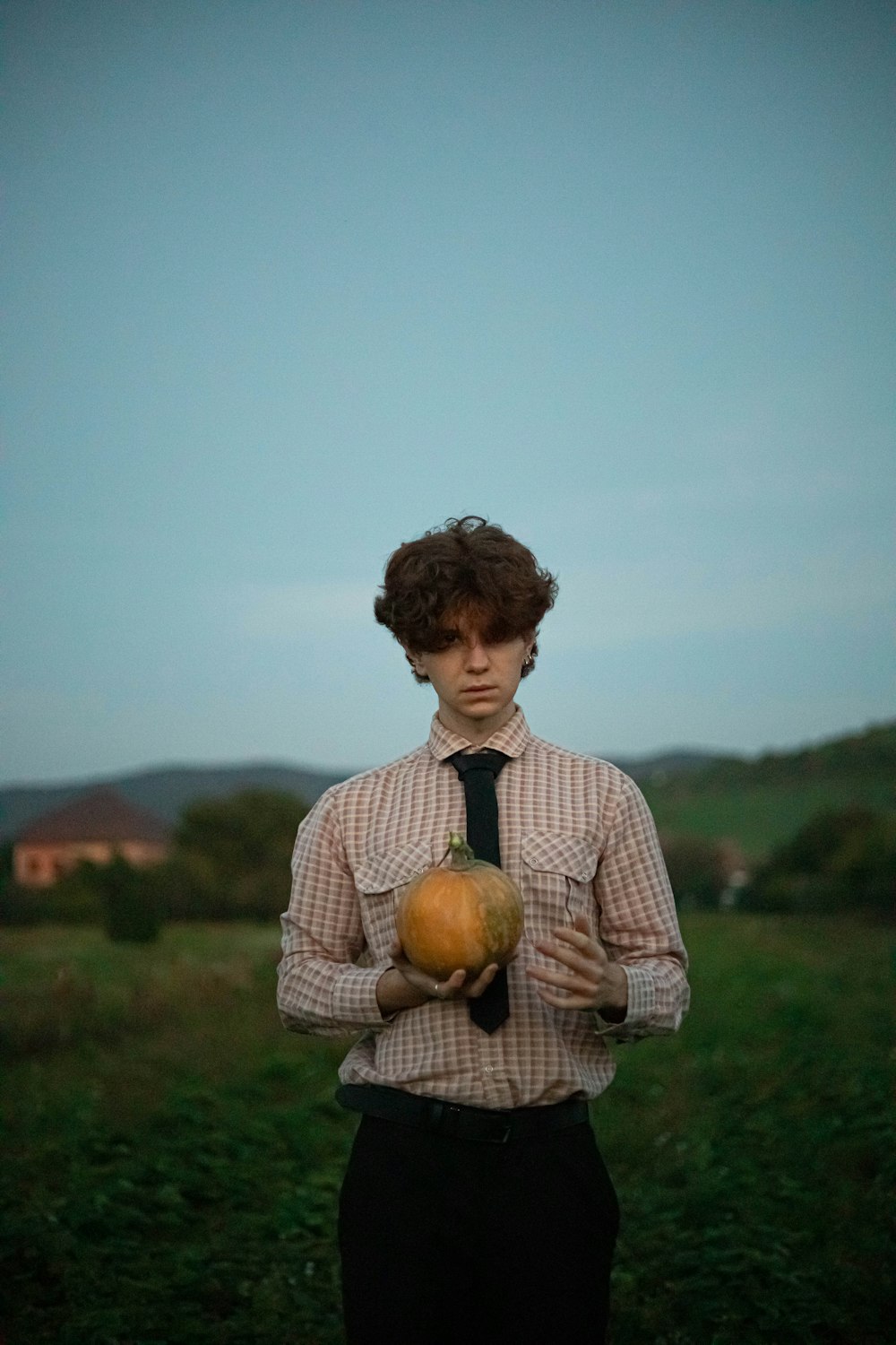 a young girl holding a pumpkin