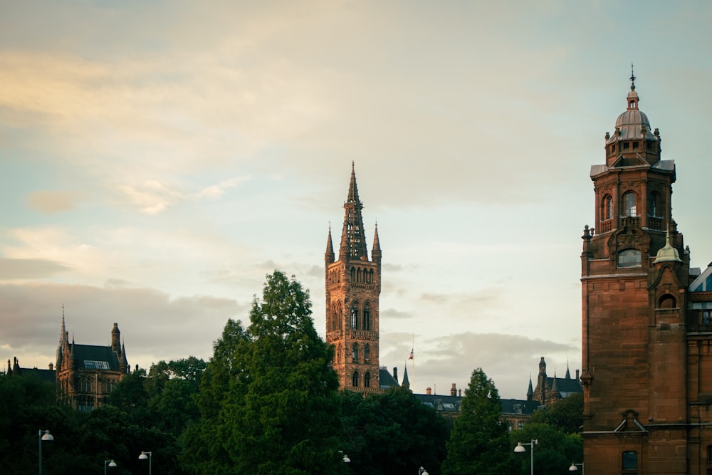 a couple of tall buildings with trees in front of them