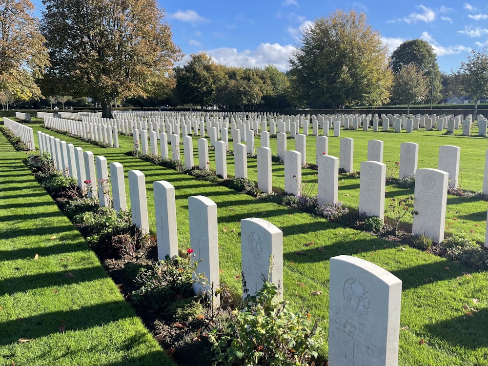 a cemetery with many white headstones