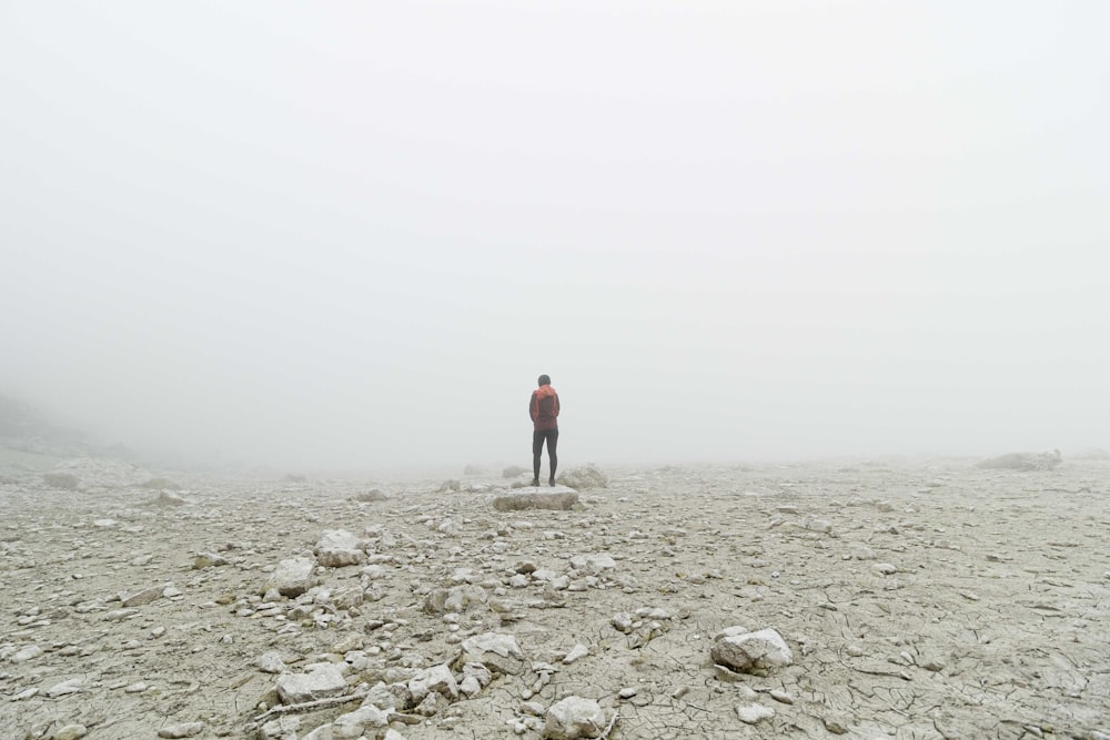 a person standing on a rocky area
