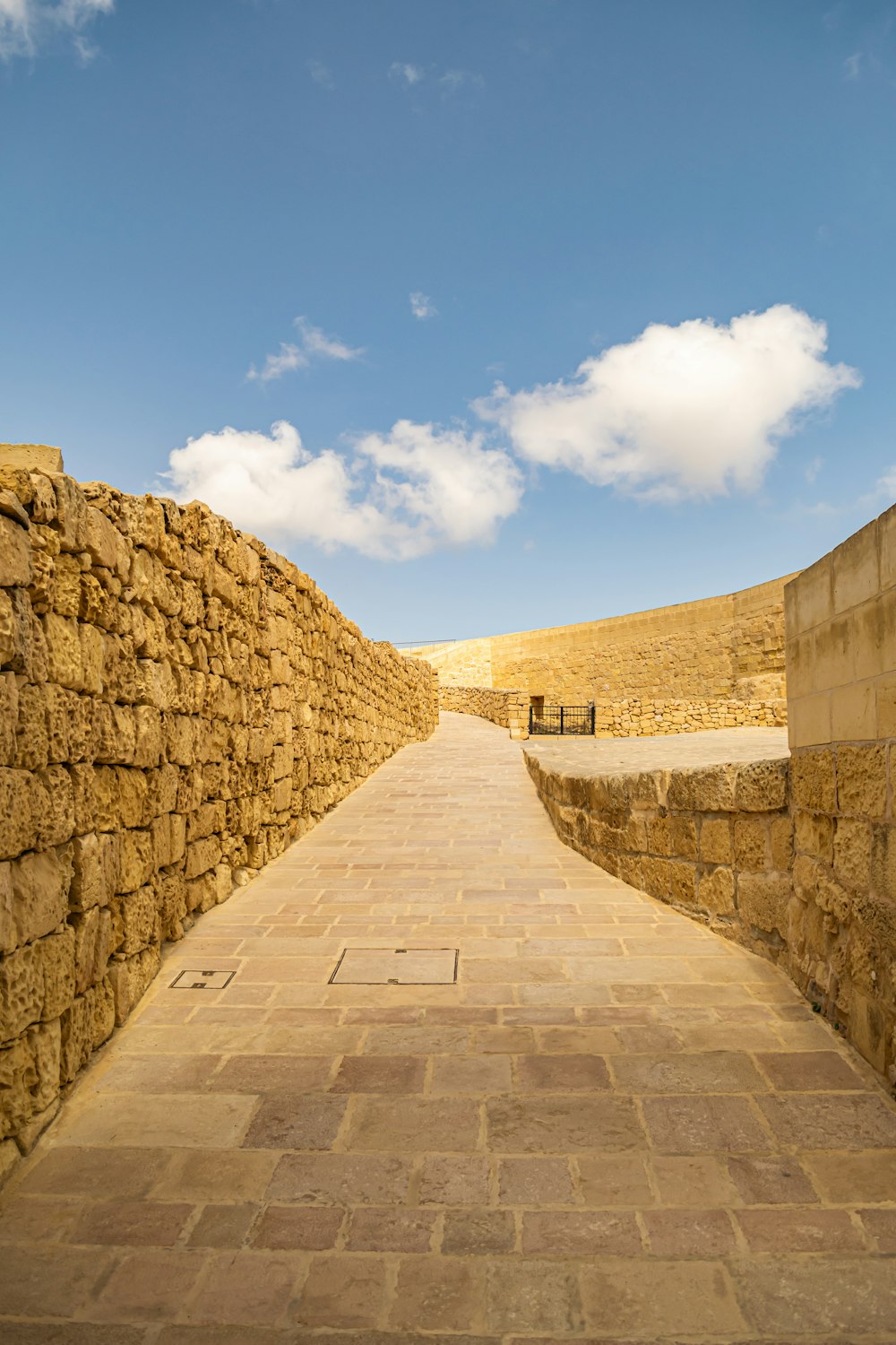 a stone wall with a stone walkway