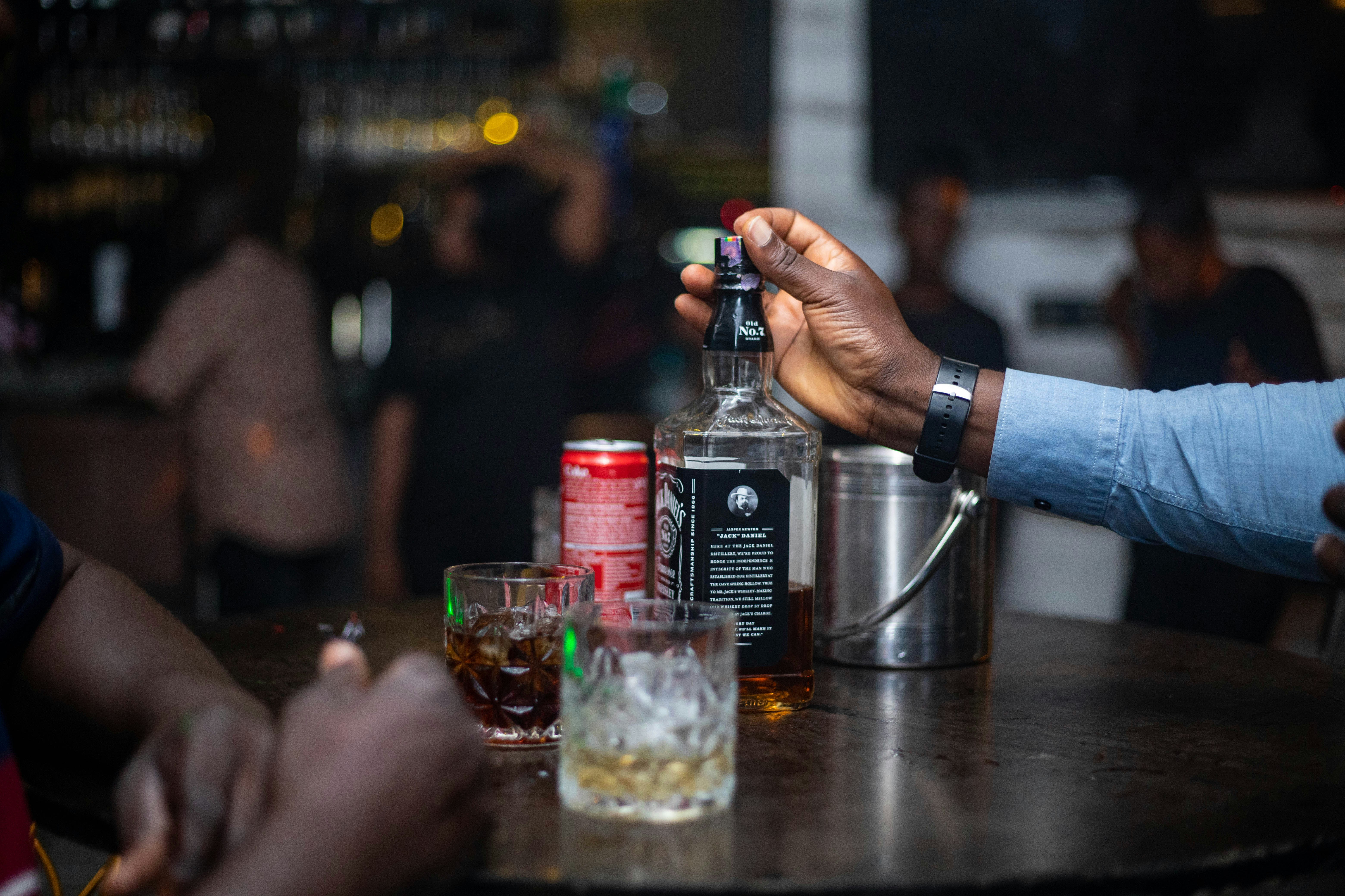 Pouring a drink at a dark bar