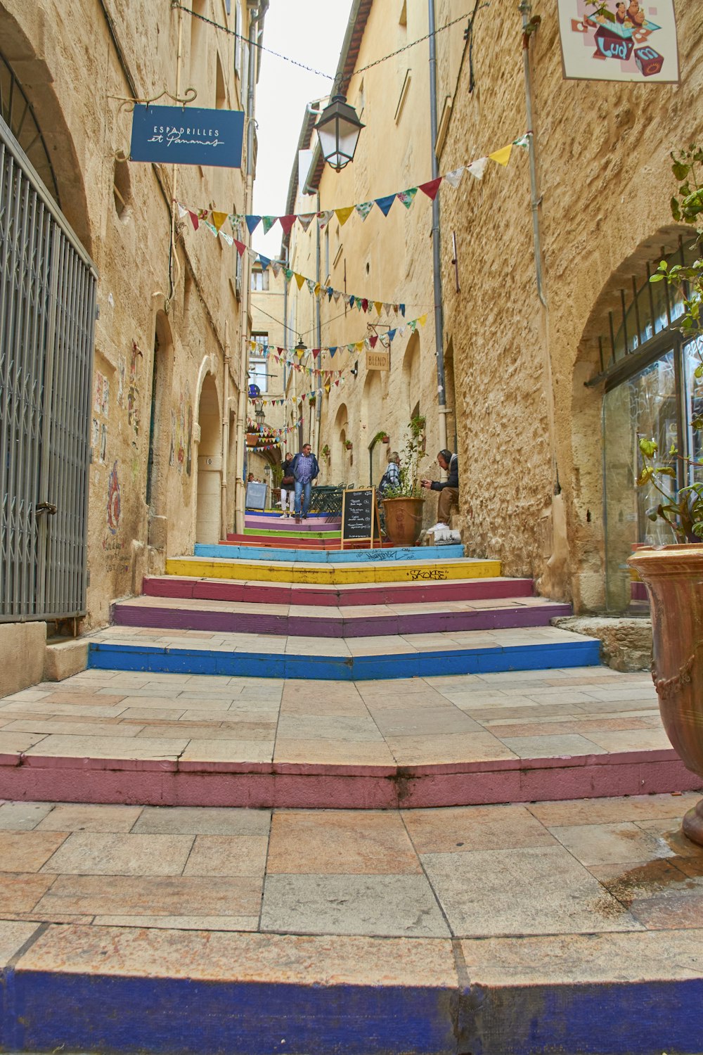 a colorful stairway in a narrow alley