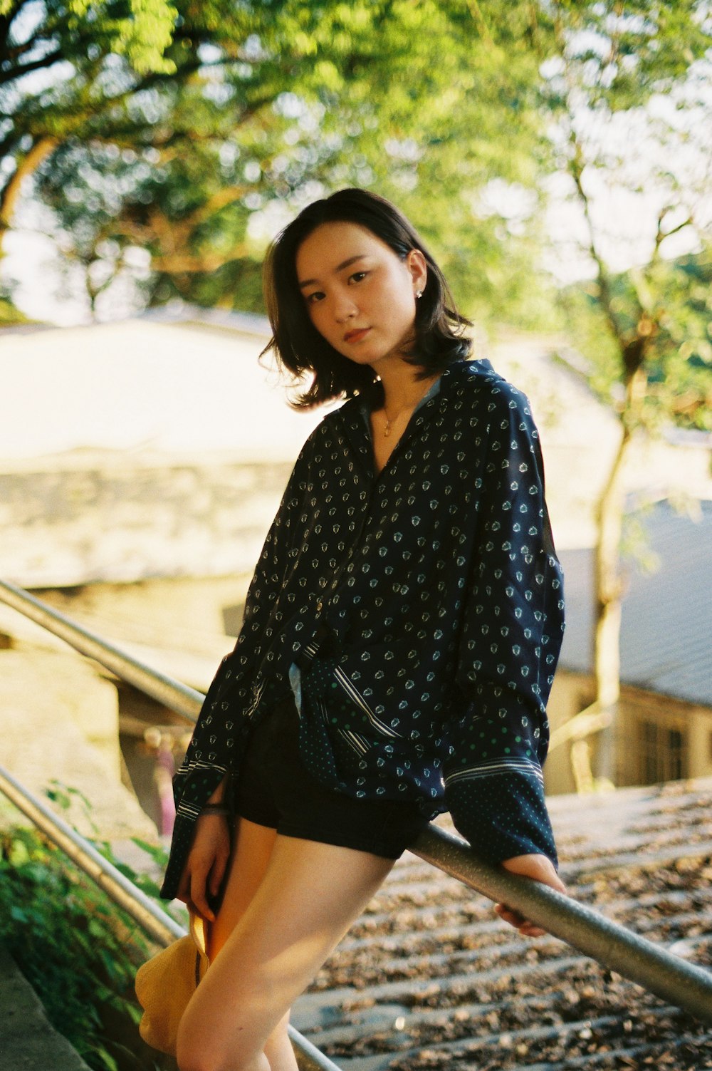 a woman sitting on a rail