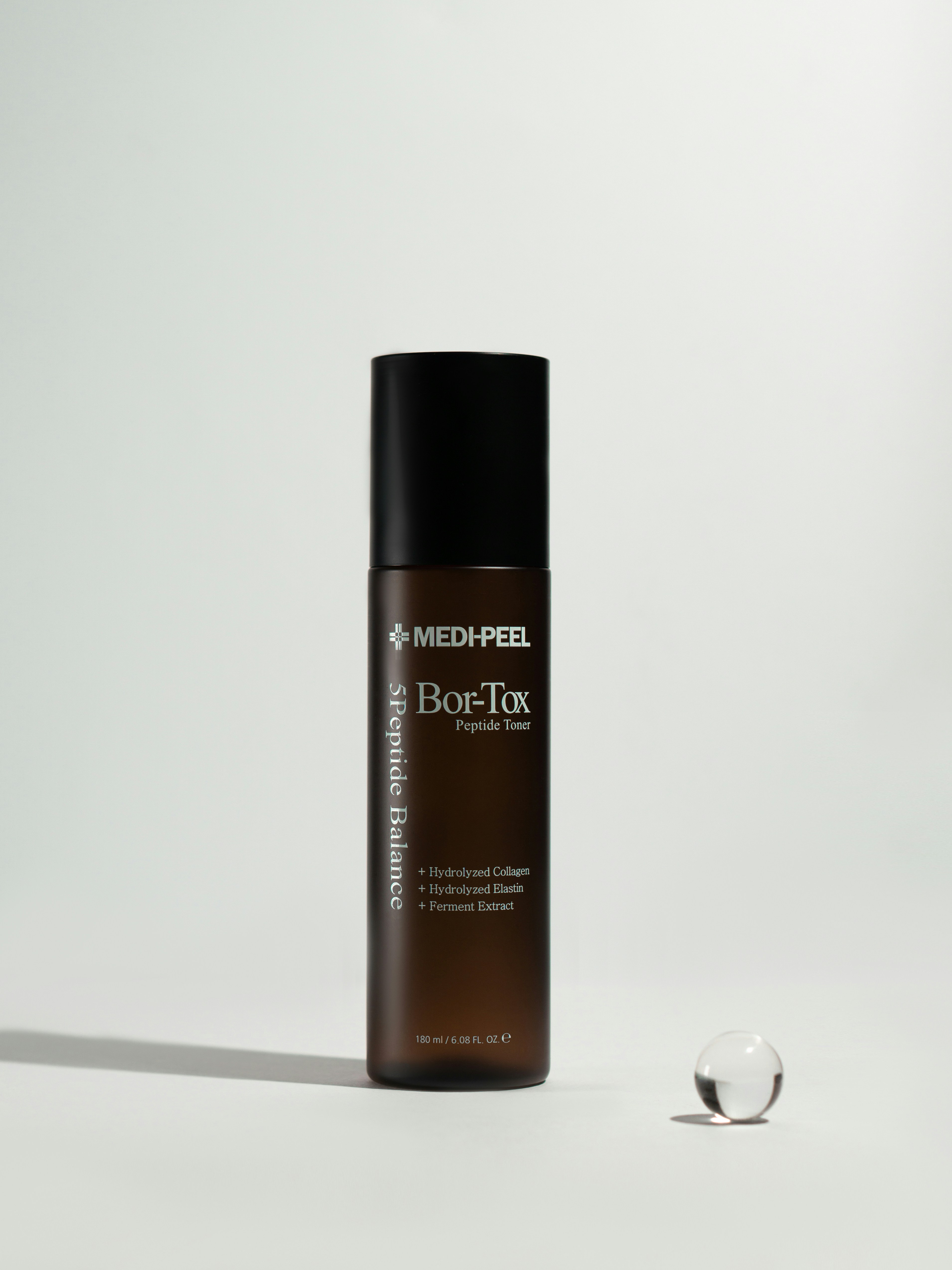 a black and white bottle of makeup