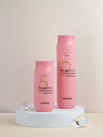 A bright and inviting display of Lumena antibacterial shampoo bottles in 500ml and 1-liter sizes surrounded by fresh bubbles.