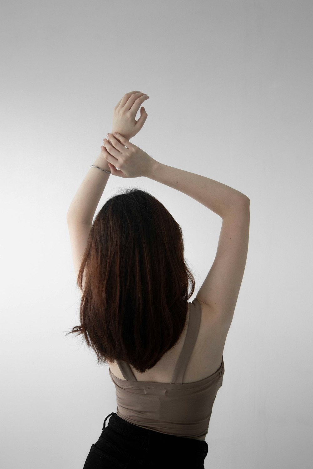 a woman holding her hair up