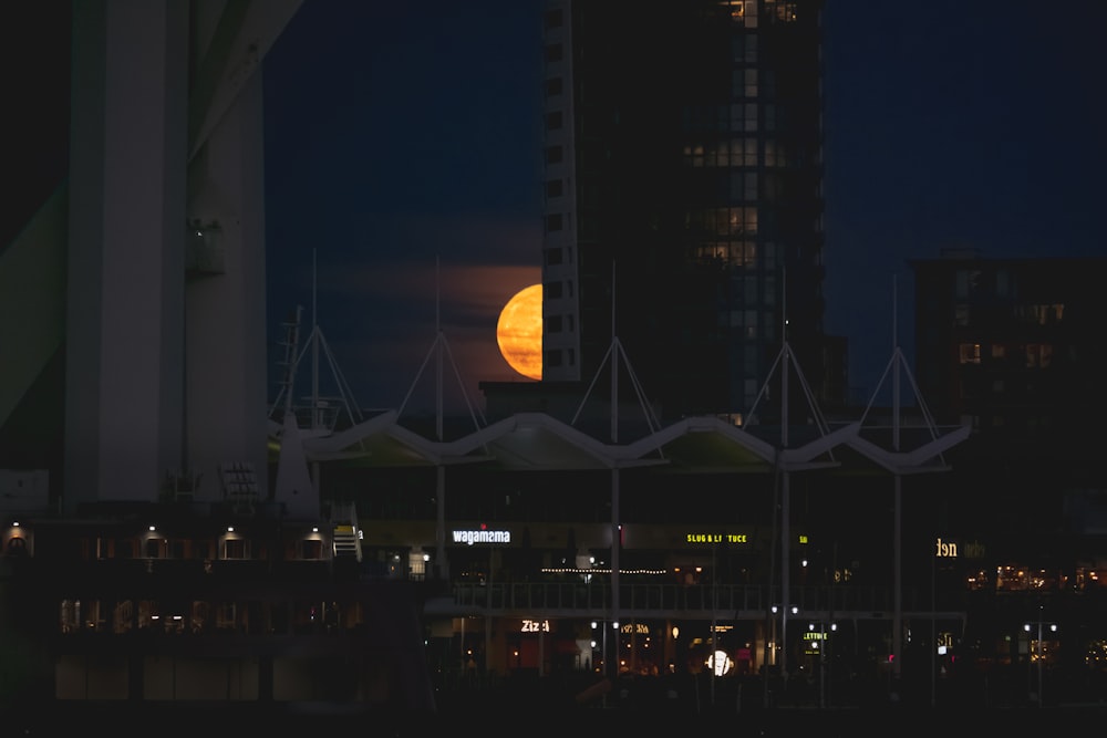 a building with a large moon in the background