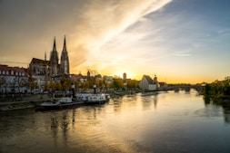 a river with boats on it and buildings on the side