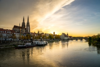 a river with boats on it and buildings on the side