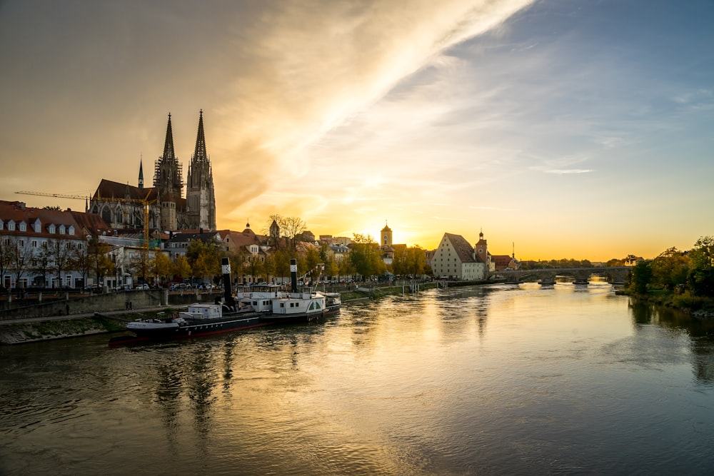 a river with boats on it and buildings on the side