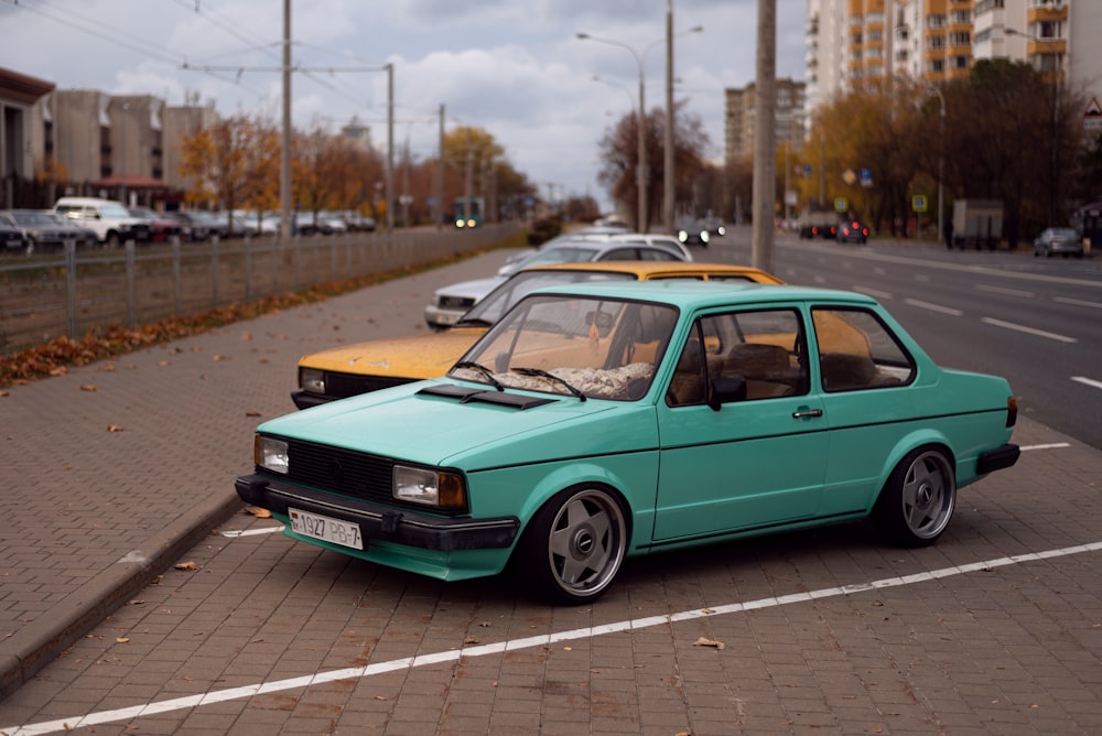 a green car parked on the side of a road