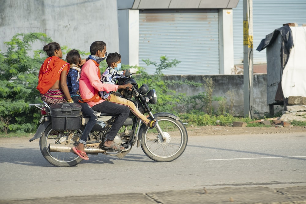 a group of people ride on a motorcycle
