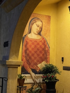A serene portrait of Vinka Maharani in a softly lit room surrounded by books and notes, reflecting thoughtful engagement.