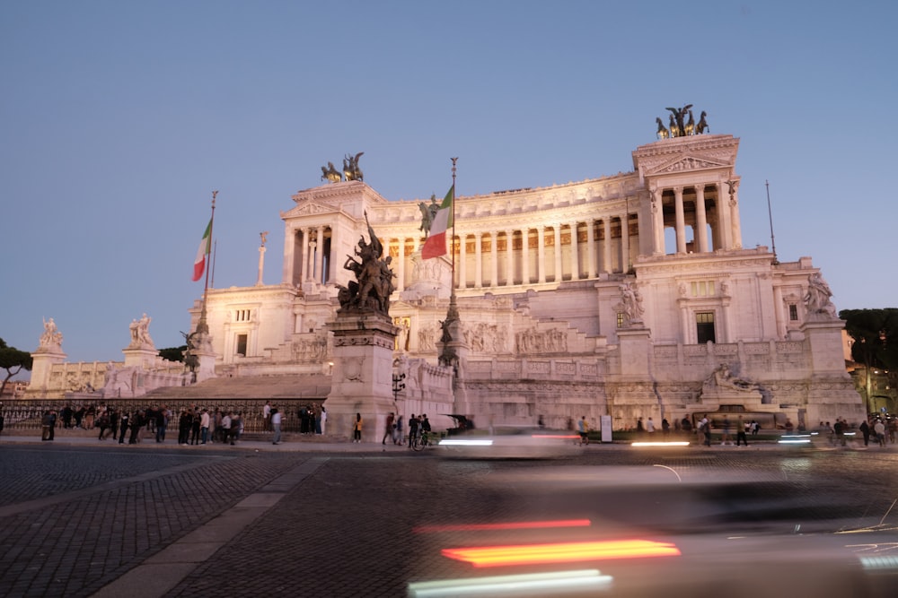 a large white building with columns and a statue on top