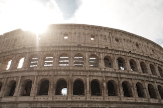 Historic architecture of Rome’s Colosseum bathed in golden afternoon light.