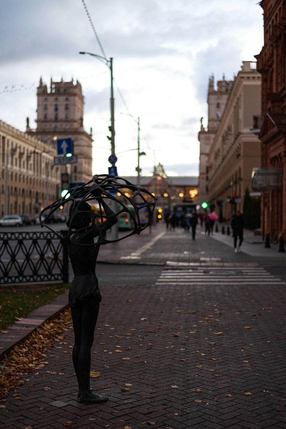 a person in a garment on a street with buildings and people