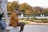 A man reflecting while using the wello app in a peaceful park.