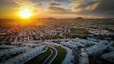 a city with a road and a sunset