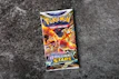 A detailed shot of a sealed Pokémon booster box with vibrant artwork visible.